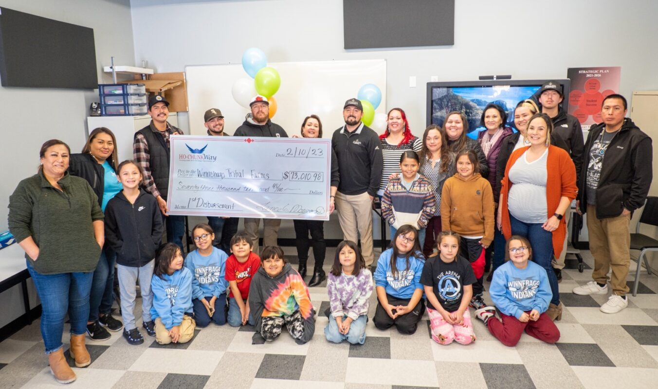 Ho-Chunk Tribal Farm team members and other Ho-Chunk employees with large check