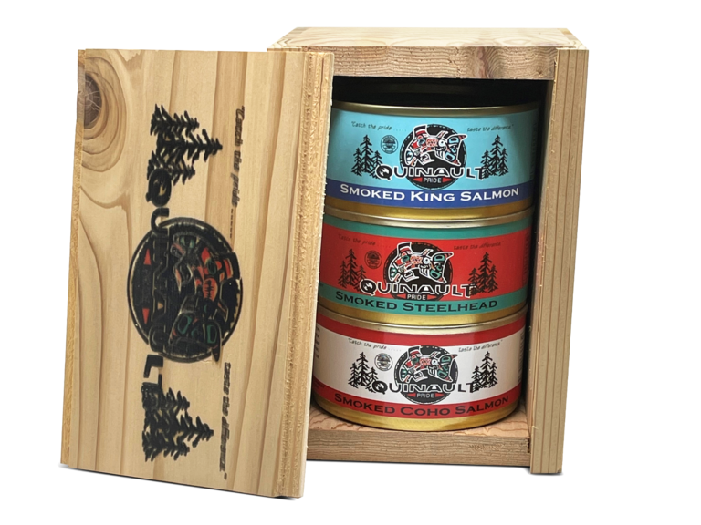 Wooden box with three cans of Quinault Pride seafood; smoked king salmon, smoked steelhead and smoked coho salmon