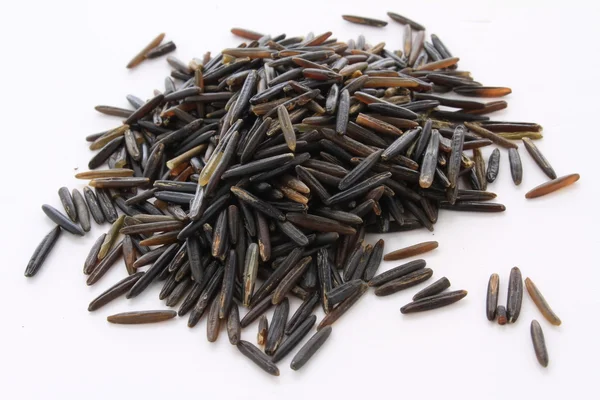 Uncooked wild rice on a white background