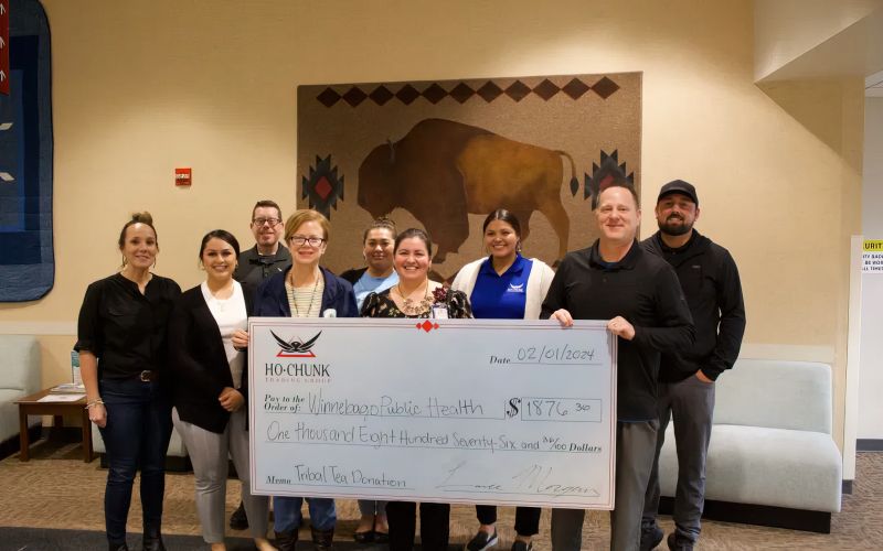 Ho-Chunk, Inc., and Winnebago Public Health employees with large check for $1876.30.