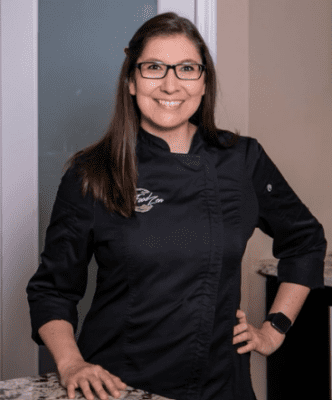 Photo of Chef Destiny Moser wearing a black top with the FoodZen logo